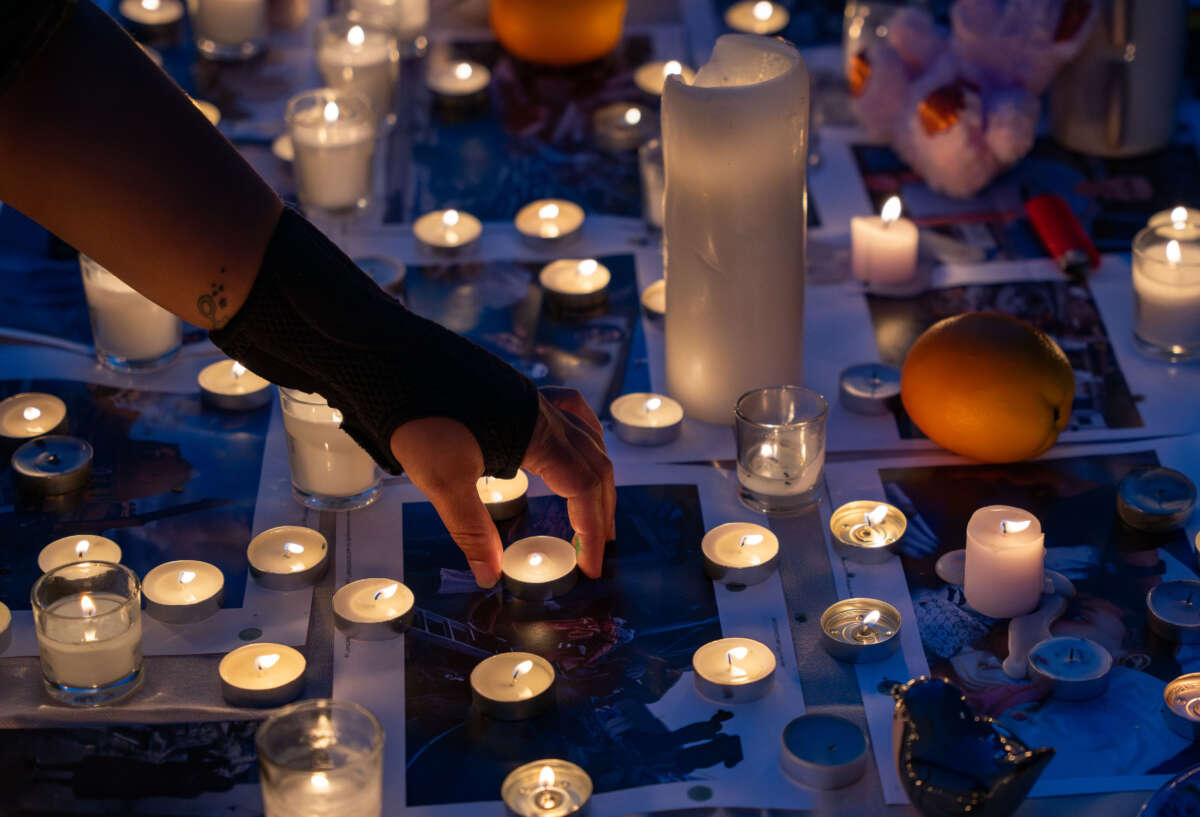 A woman places a candle in memory of Palestinians killed in Gaza after a rally as hundreds of Palestinian Americans and supporters gather in support of Palestine at Public Square Plaza in Nashville, Tennessee, on October 22, 2023.