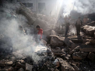 Palestinians inspect the debris at the Jaffa Mosque, which was hit by an Israeli bombardment, in Deir al-Balah, in the central Gaza Strip, on December 8, 2023.