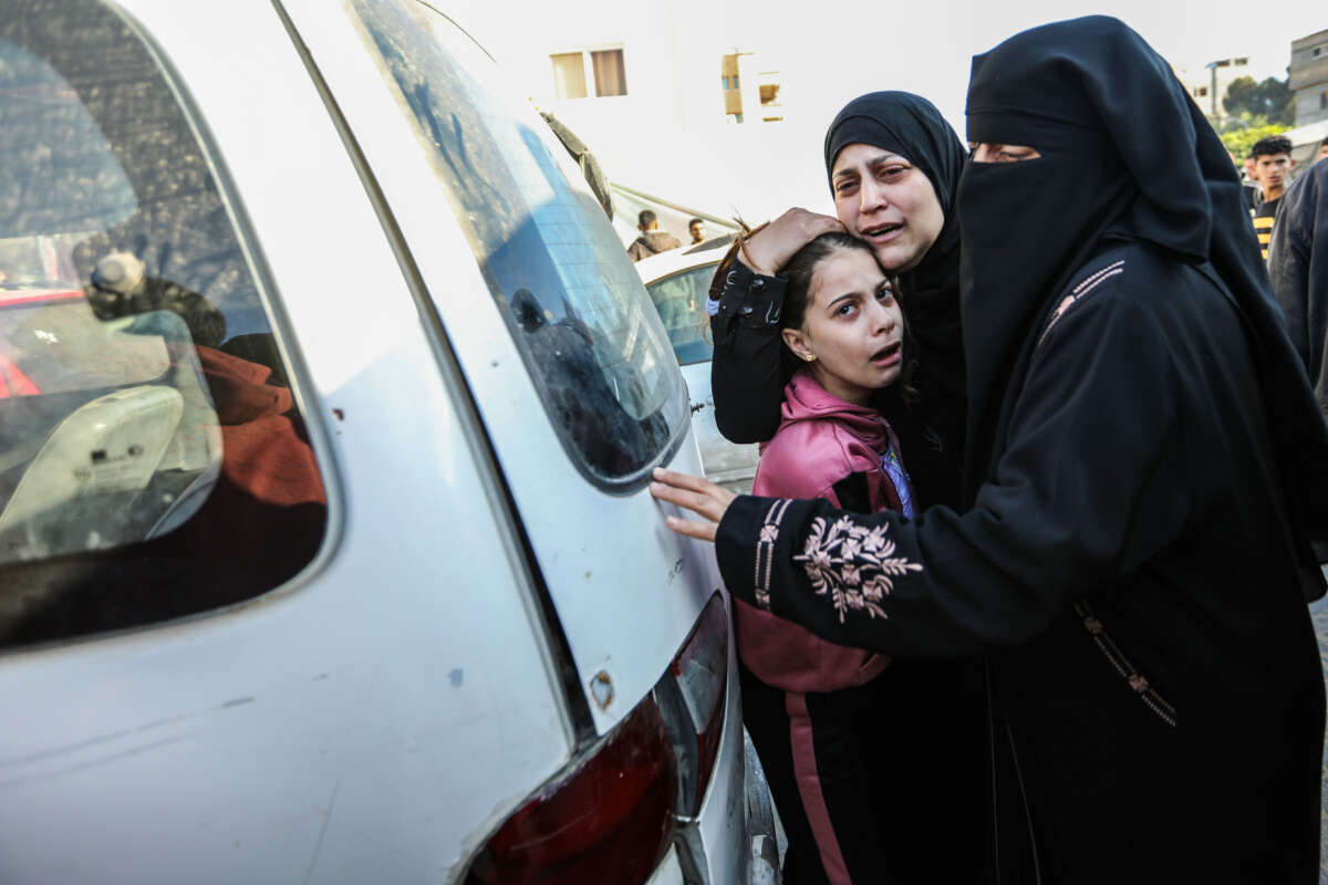 People mourn as they collect the bodies of Palestinians killed in an airstrike on December 11, 2023, in Khan Yunis, Gaza.