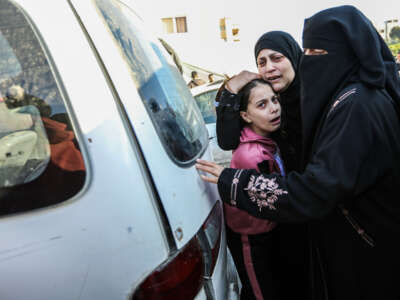 People mourn as they collect the bodies of Palestinians killed in an airstrike on December 11, 2023, in Khan Yunis, Gaza.