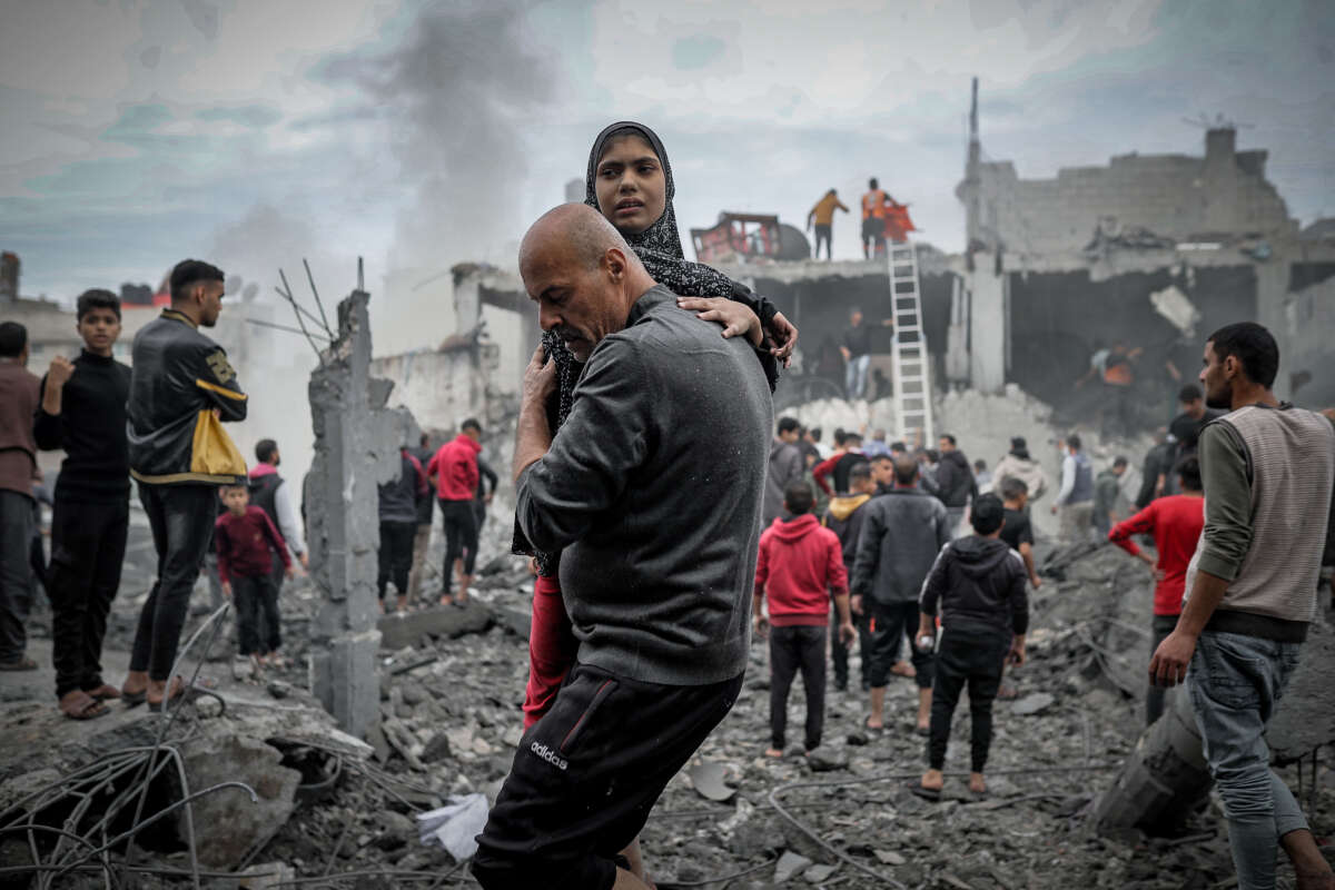 Residents and civil defense teams conduct a search and rescue operation around the rubble of a building that collapsed following an Israeli attack in Khan Yunis, Gaza, on December 7, 2023.