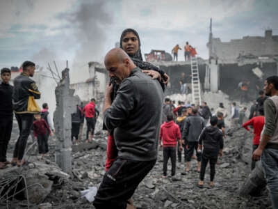 Residents and civil defense teams conduct a search and rescue operation around the rubble of a building that collapsed following an Israeli attack in Khan Yunis, Gaza, on December 7, 2023.