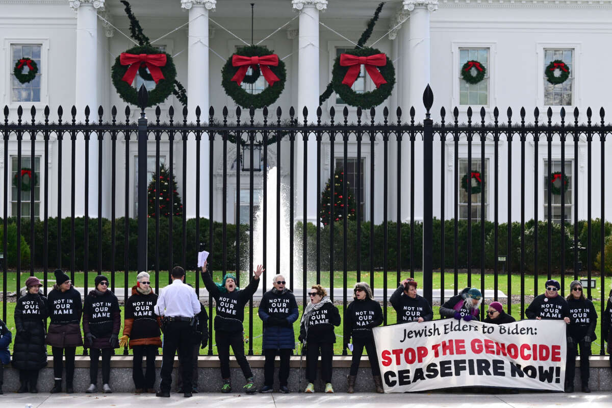 A group calling for a ceasefire in the conflict in the Israel and Gaza region chain themselves to the fence outside the White House on December 11, 2023, in Washington, D.C.