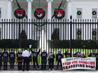A group calling for a ceasefire in the conflict in the Israel and Gaza region chain themselves to the fence outside the White House on December 11, 2023, in Washington, D.C.