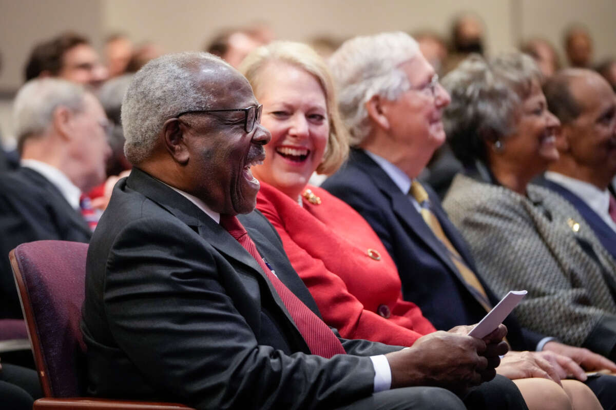 Associate Supreme Court Justice Clarence Thomas sits with his wife and conservative activist Virginia Thomas while he waits to speak at the Heritage Foundation on October 21, 2021, in Washington, D.C.