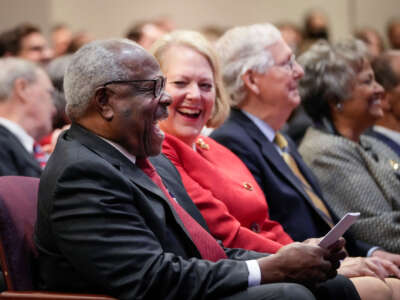 Associate Supreme Court Justice Clarence Thomas sits with his wife and conservative activist Virginia Thomas while he waits to speak at the Heritage Foundation on October 21, 2021, in Washington, D.C.
