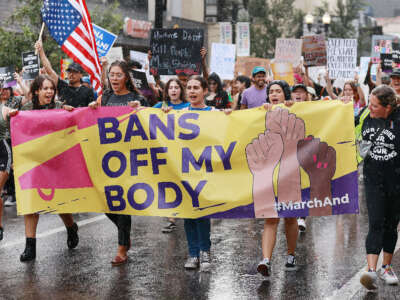 Demonstrators march in the rain during an abortion rights rally in downtown Orlando, Florida, on June 27, 2022.