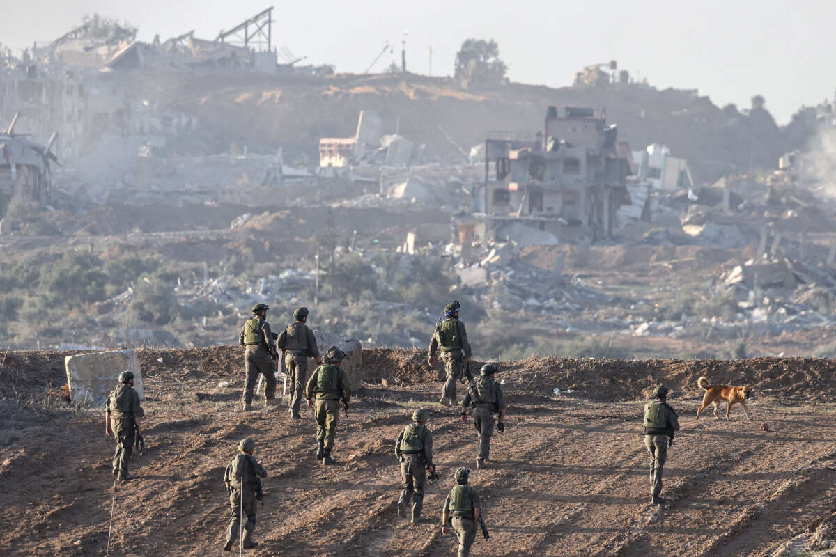 A picture taken in southern Israel near the border with the Gaza Strip on December 11, 2023, shows Israeli army soldiers taking position on a hill overlooking northern Gaza.