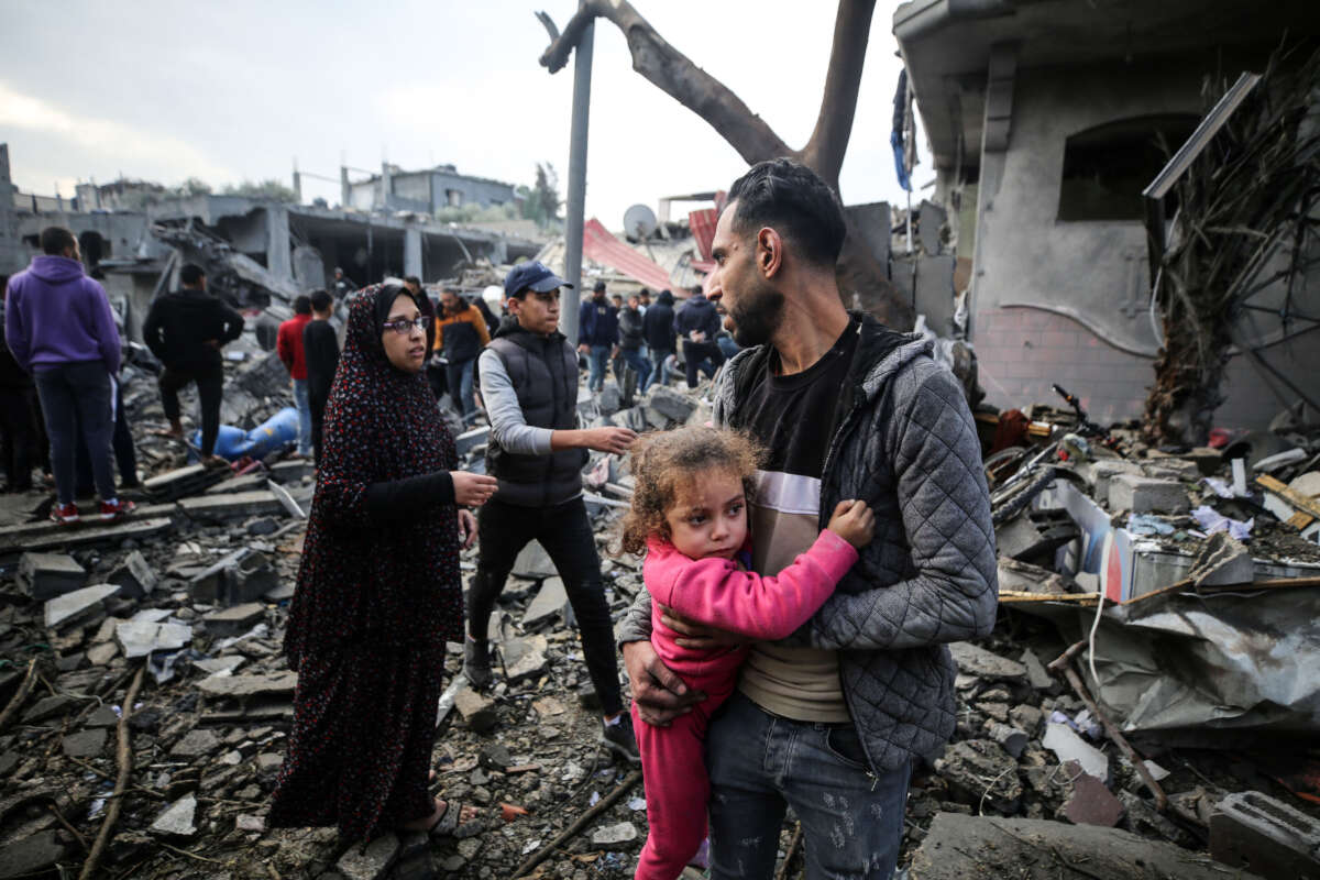 Palestinians search through rubble for survivors following Israeli strikes on the al-Maghazi refugee camp in the central Gaza Strip on December 25, 2023.