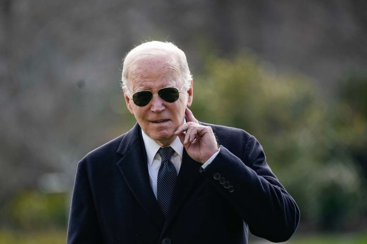 President Joe Biden listens to a question shouted from the press as he arrives at the White House on December 19, 2023, in Washington, D.C.