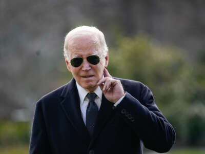 President Joe Biden listens to a question shouted from the press as he arrives at the White House on December 19, 2023, in Washington, D.C.