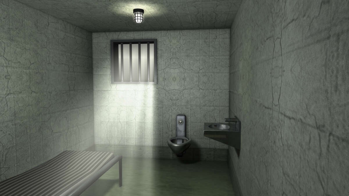 An empty jail cell in a traditional prison.