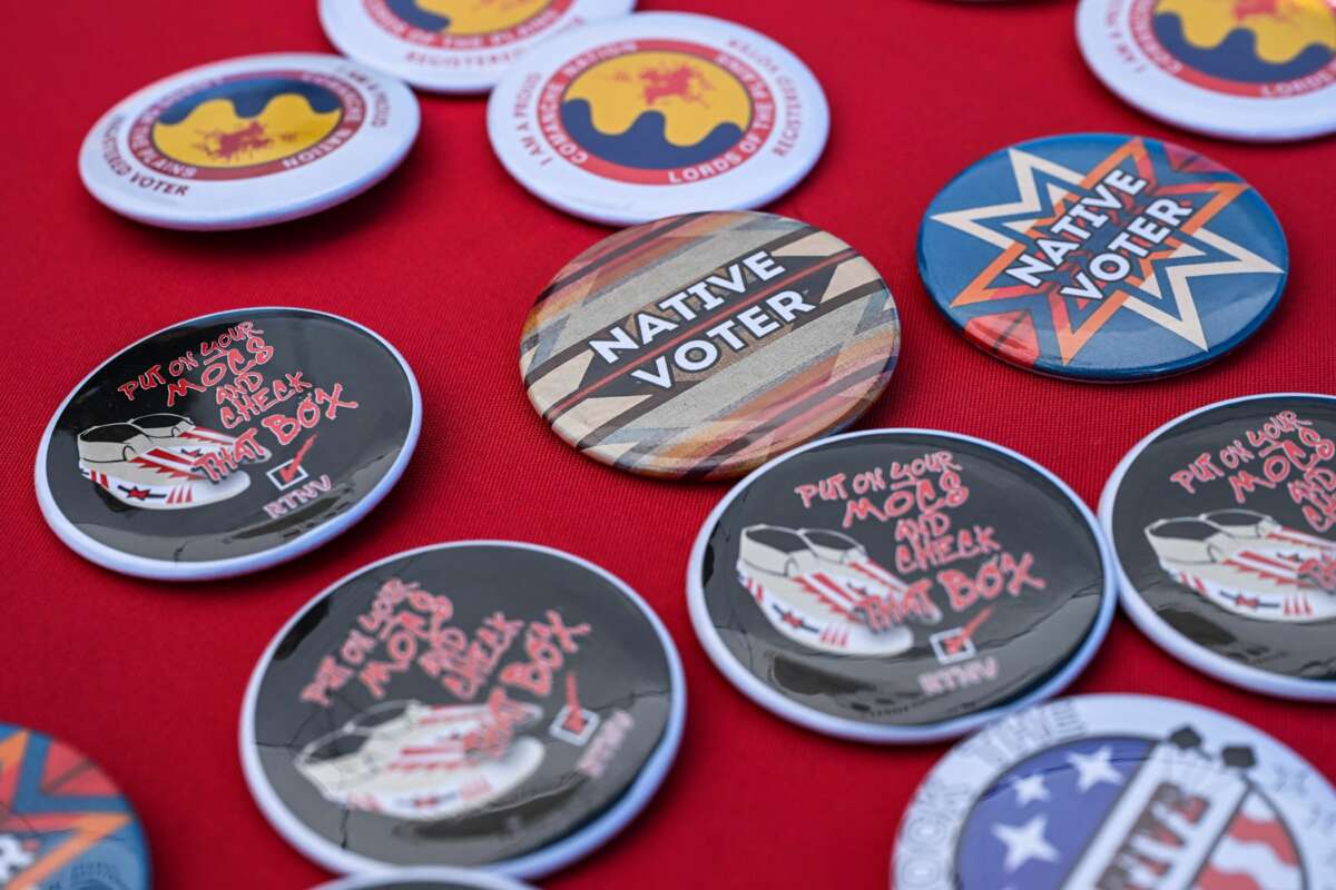 Pins reading "Native Voter" are pictured at a display counter during a cultural meeting at the Comanche Nation fairgrounds in Lawton, Oklahoma, on September 30, 2023.