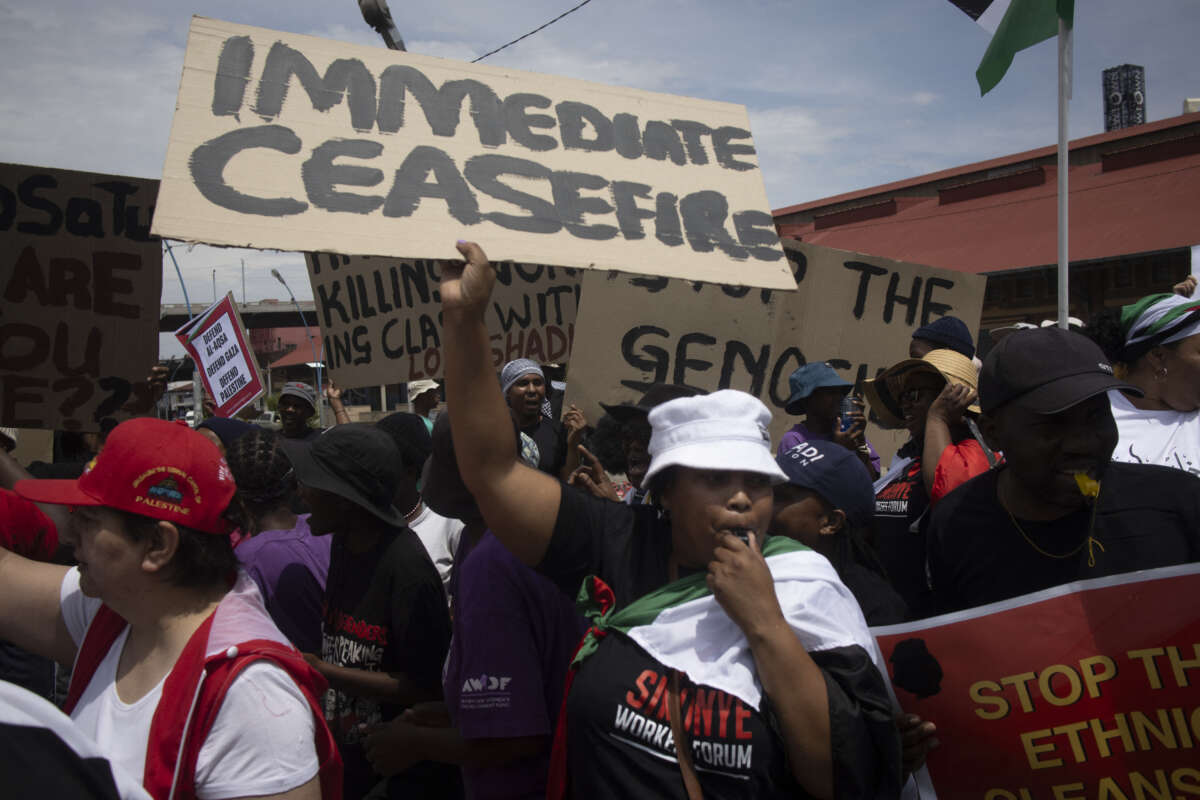 Demonstrators hold placards during a pro-Palestinian demonstration by various political parties and trade unions in Johannesburg, South Africa, on November 29, 2023.