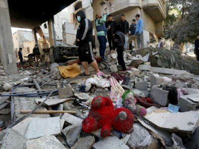 A teddy bear is seen among the rubble of an almost completely collapsed building after an Israeli attack on Nuseirat refugee camp in Deir al-Balah, Gaza, on December 30, 2023.