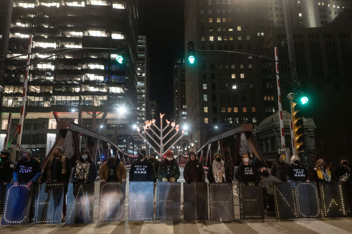 Jewish organizers and their allies participate in a demonstration at the Washinton Street Bridge in Chicago, Illinois, blocking traffic as part of protest to draw attention to Israel's attacks on Gaza, on December 14, 2023.