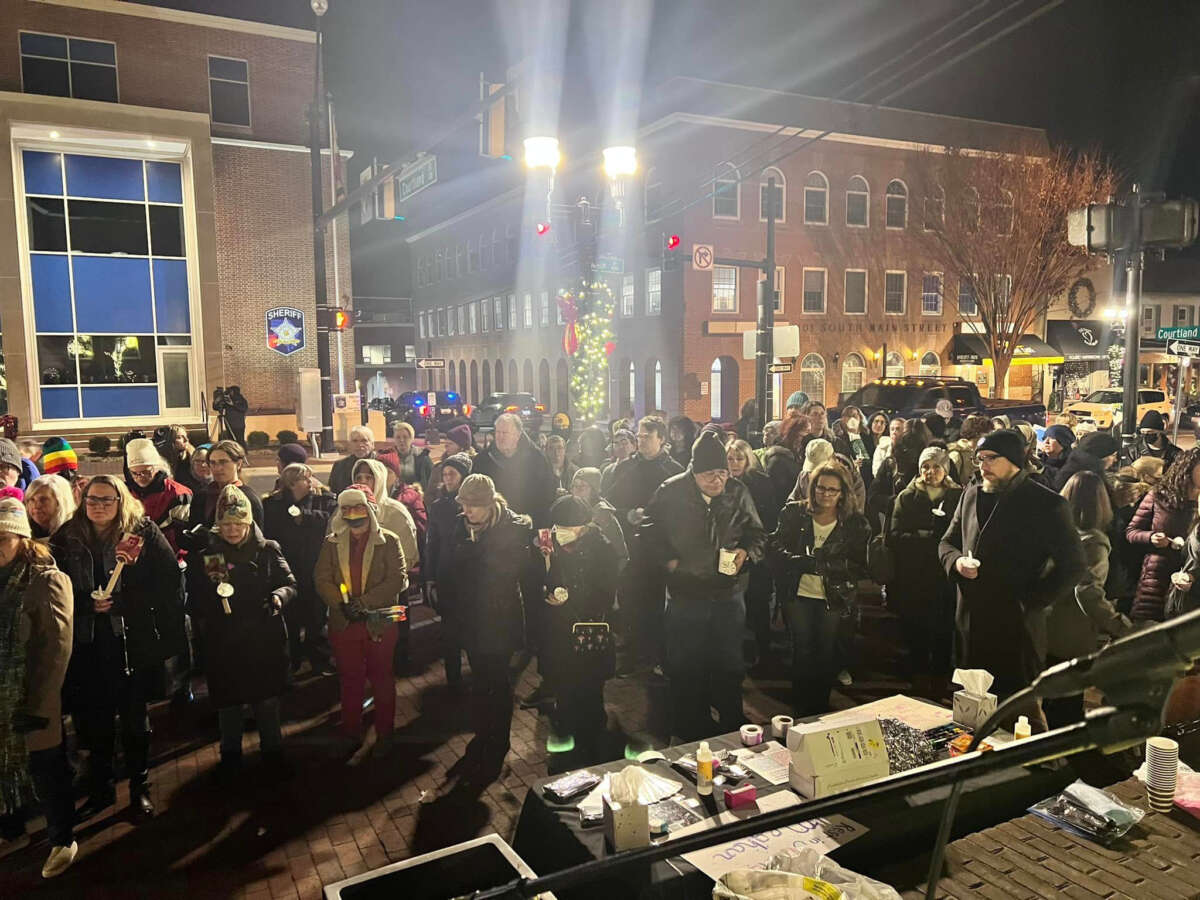 People gather at a vigil for Meghan Lewis.