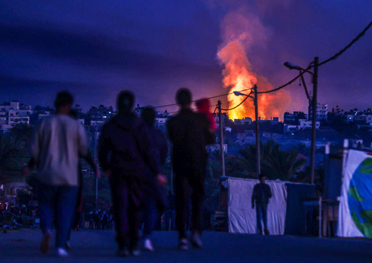 Smoke and flame rises from different parts of Salah al-Din Road following Israeli attacks in Deir Al Balah, Gaza, on January 7, 2024.