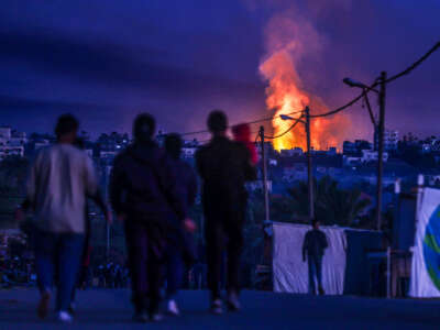 Smoke and flame rises from different parts of Salah al-Din Road following Israeli attacks in Deir Al Balah, Gaza, on January 7, 2024.