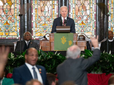 President Joe Biden watches as protestors are escorted out of the building while supporters chant, "Four more years," during a campaign event at Emanuel AME Church on January 8, 2024, in Charleston, South Carolina.