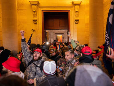 Trump supporters breach through the Columbus doors as they clash with law enforcement on the west steps / inauguration stage of the U.S. Capitol on January 6, 2021, in Washington, D.C.