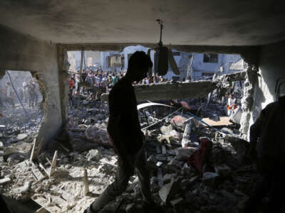 Civil defense teams and citizens continue search and rescue operations after an airstrike hit a building belonging to the Maslah family during the 32nd day of Israeli attacks in Deir Al-Balah, Gaza, on November 7, 2023.