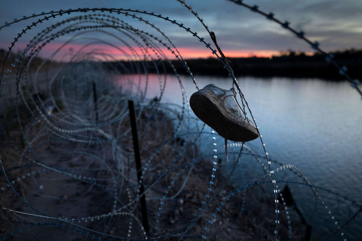 A child's shoe hangs caught in razor wire atop the bank of the Rio Grande on January 9, 2024, in Eagle Pass, Texas.