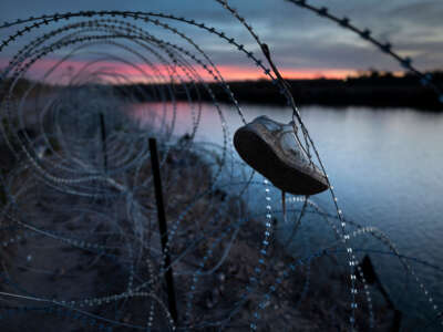 A child's shoe hangs caught in razor wire atop the bank of the Rio Grande on January 9, 2024, in Eagle Pass, Texas.