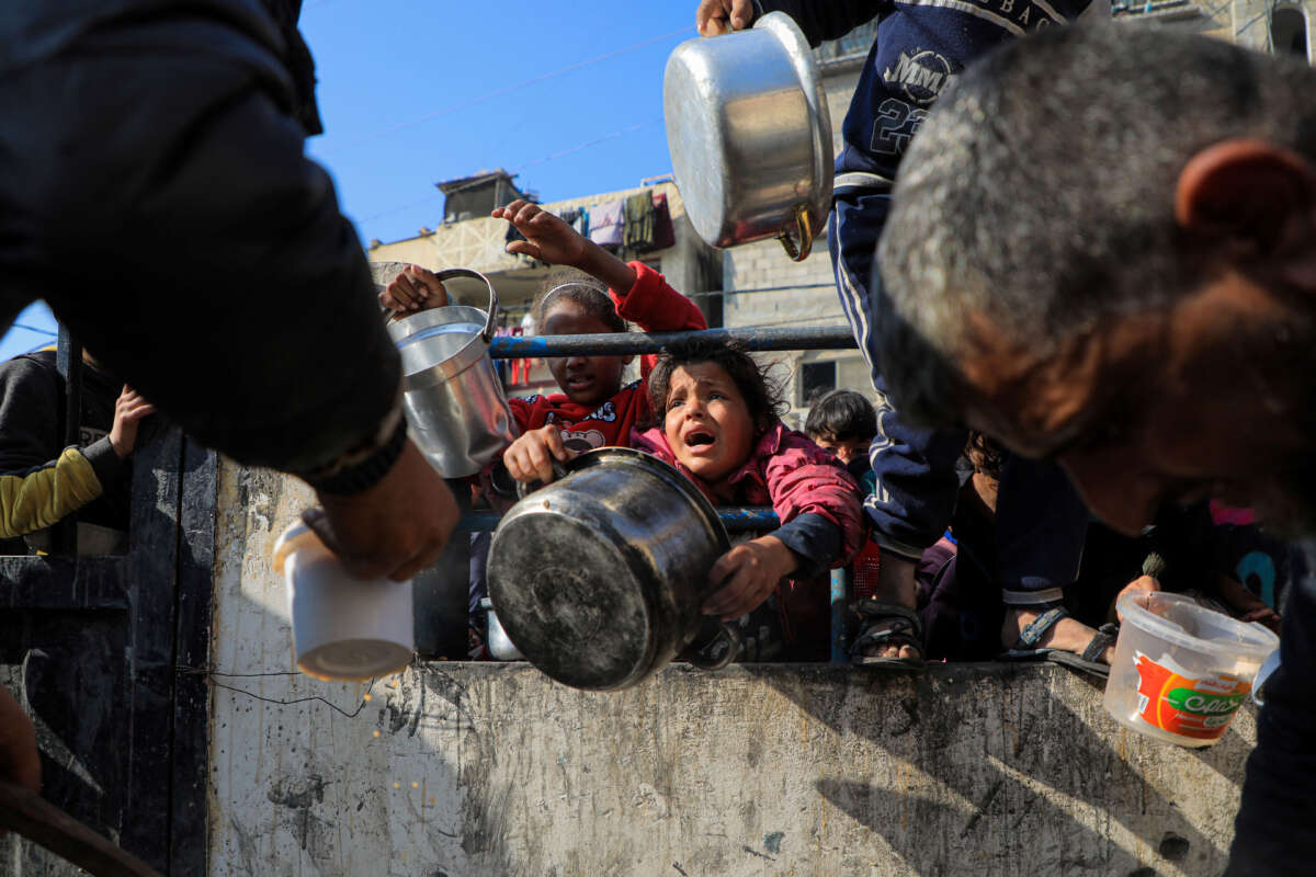 Children wait for food relief in the southern Gaza Strip city of Rafah, on December 31, 2023.