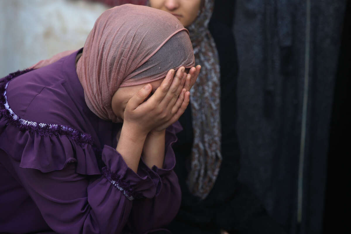 Palestinians mourn the death of loved ones following Israeli bombardment on January 18, 2024, in Rafah in the southern Gaza Strip.