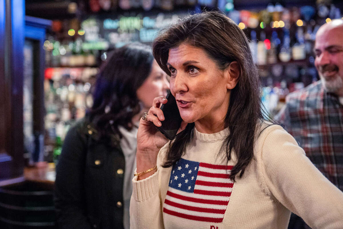 Nikki Haley speaks to someone on her cellphone during a campaign event