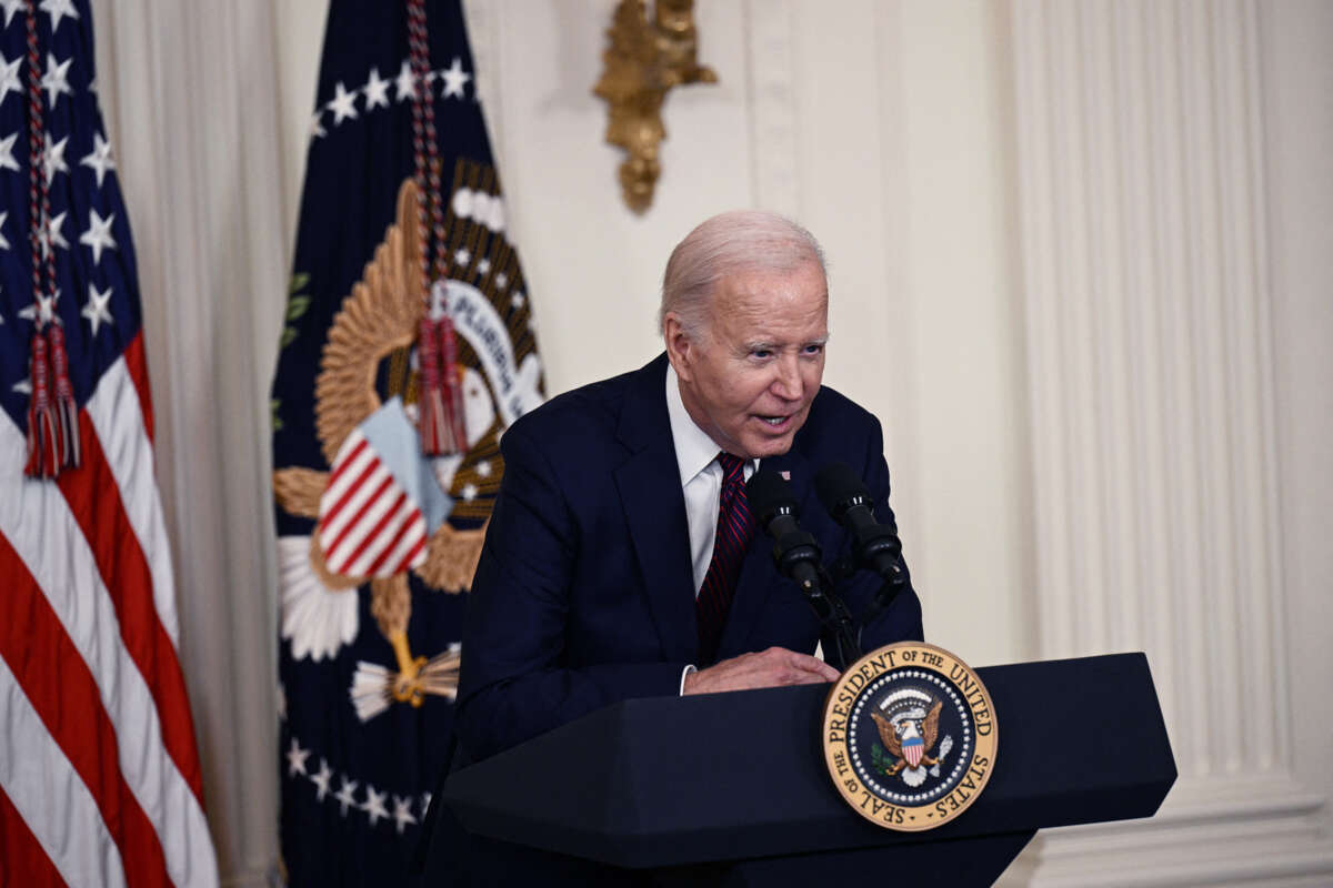 Joe Biden leans over the podium at which he speaks