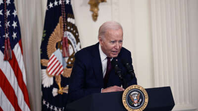 Joe Biden leans over the podium at which he speaks