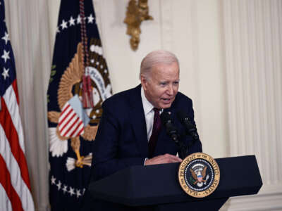 Joe Biden leans over the podium at which he speaks