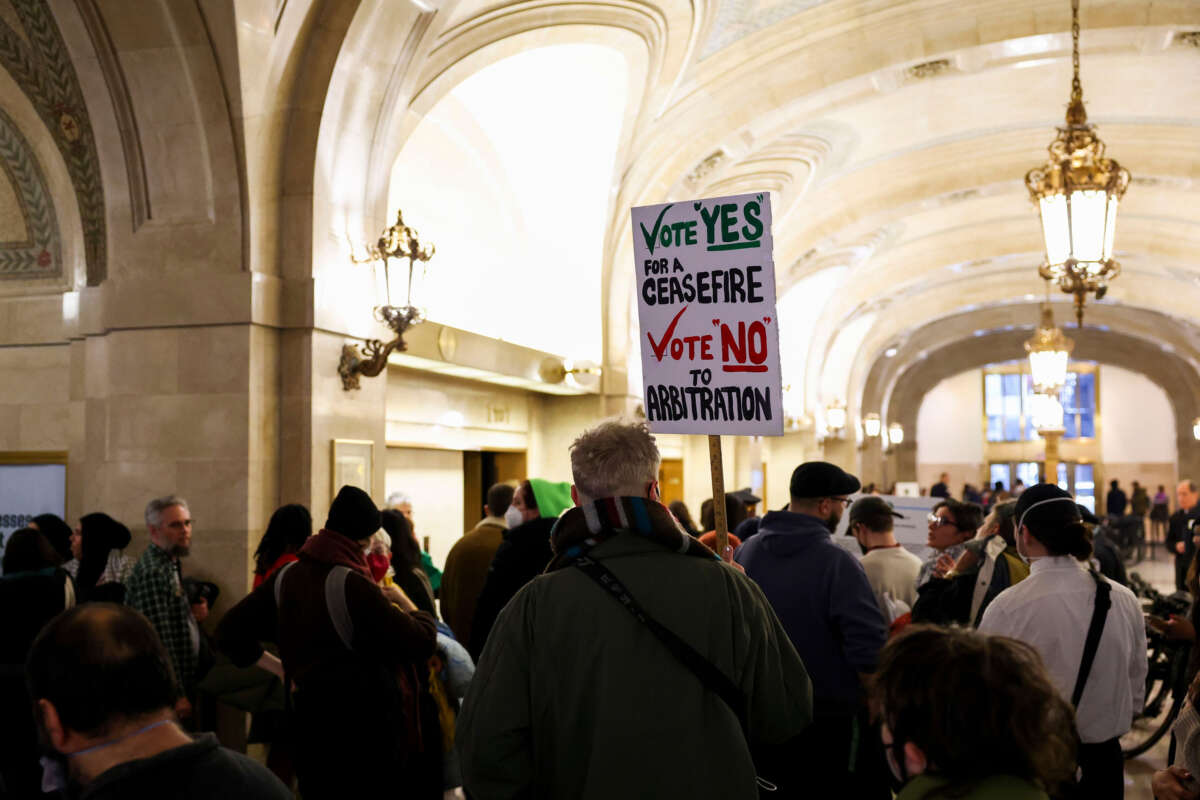 People wait in line to attend a Chicago City Council meeting at City Hall on January 24, 2024.