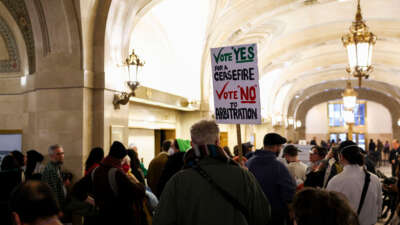 People wait in line to attend a Chicago City Council meeting at City Hall on January 24, 2024.