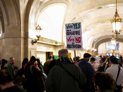 People wait in line to attend a Chicago City Council meeting at City Hall on January 24, 2024.