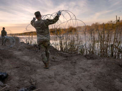 Texas National Guard soldiers install additional razor wire lie along the Rio Grande on January 10, 2024, in Eagle Pass, Texas.