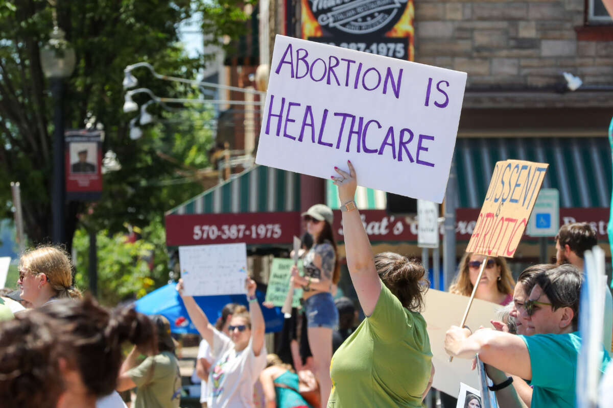 A woman holds a placard saying 'abortion is healthcare' during an abortion rights rally in Bloomsburg, Pennsylvania, on July 3, 2022.