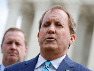 Texas Attorney General Ken Paxton (right) talks to reporters outside the U.S. Supreme Court on April 26, 2022, in Washington, D.C.