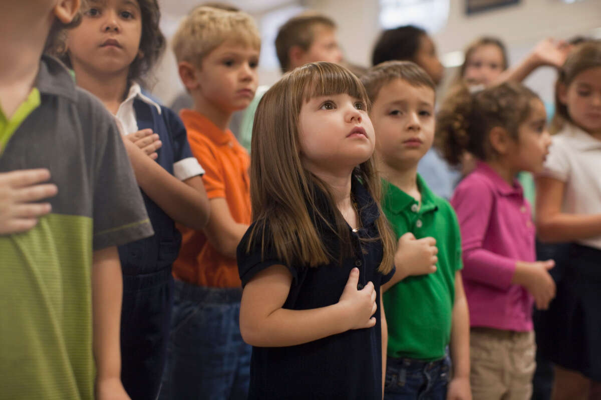 Kids in classroom reciting pledge of allegience