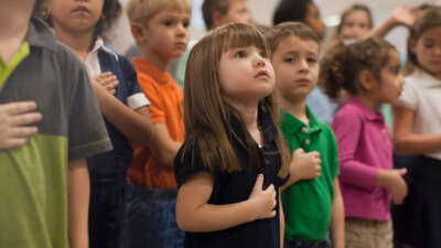 Kids in classroom reciting pledge of allegience