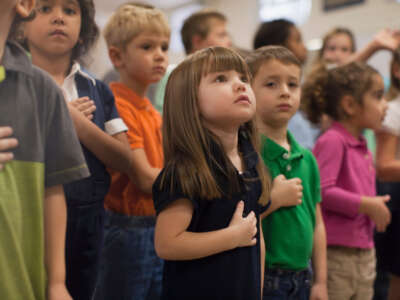 Kids in classroom reciting pledge of allegience