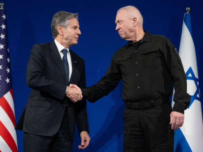 Israeli Defense Minister Yoav Gallant (right) and U.S. Secretary of State Antony Blinken shake hands prior to a meeting in Tel Aviv on November 30, 2023.