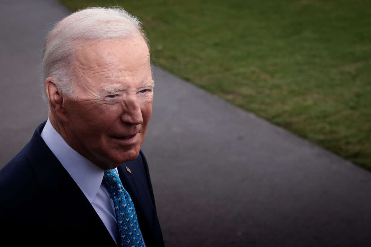 Joe Biden squints into the distance as his face is half in shadow