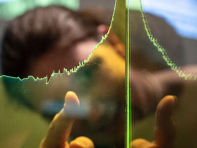 A visitor stands by a Keeling curve showing the CO2 concentration in the atmosphere over time in the special exhibition "Digital Forest" at Forum Wissen in Lower Saxony, Göttingen, on October 25, 2023.