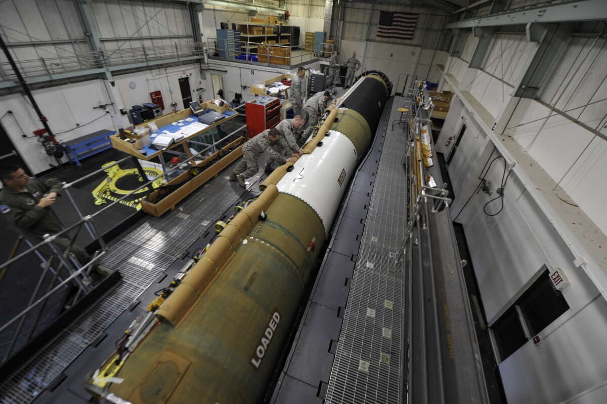 U.S. Air Force airman install a cable raceway on an intercontinental ballistic missile