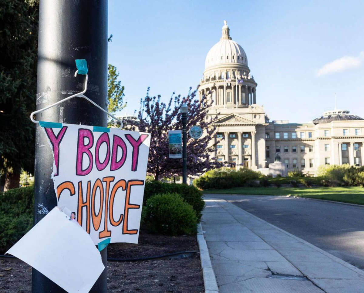 A sign is taped to a hanger taped to a streetlight in front of the Idaho Capitol in Boise, Idaho, on May 3, 2022.