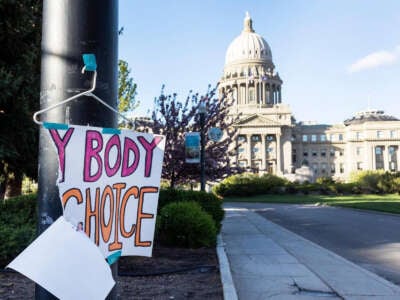 A sign is taped to a hanger taped to a streetlight in front of the Idaho Capitol in Boise, Idaho, on May 3, 2022.