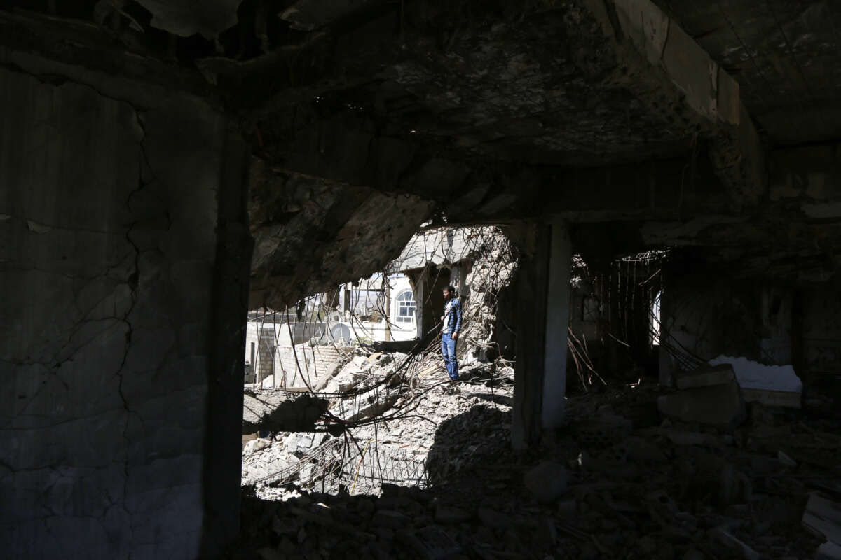 A Yemeni man inspects a house that was destroyed in an airstrike carried out during the Yemen war by the Saudi-led coalition's warplanes, on February 5, 2021, in Sana'a, Yemen.